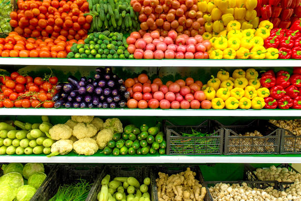 Fresh organic Vegetables and fruits on shelf in supermarket, farmers market. Healthy food concept. Vitamins and minerals. Tomatoes, capsicum, cucumbers, mushrooms, zucchini, stock photo