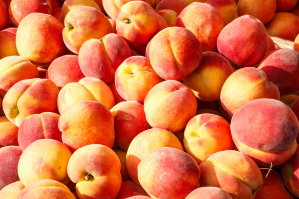 Fresh Peaches at an Outdoor Market stock photo