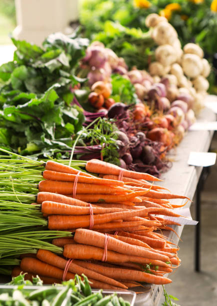 Fresh picked carrots and beets at a local market stock photo
