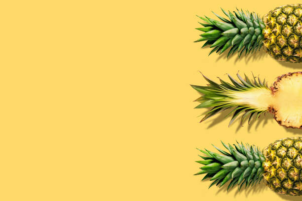 Fresh pineapples on yellow background. Creative suumer concept. Fresh pineapples on yellow background. Creative suumer concept. pineapple stock pictures, royalty-free photos & images