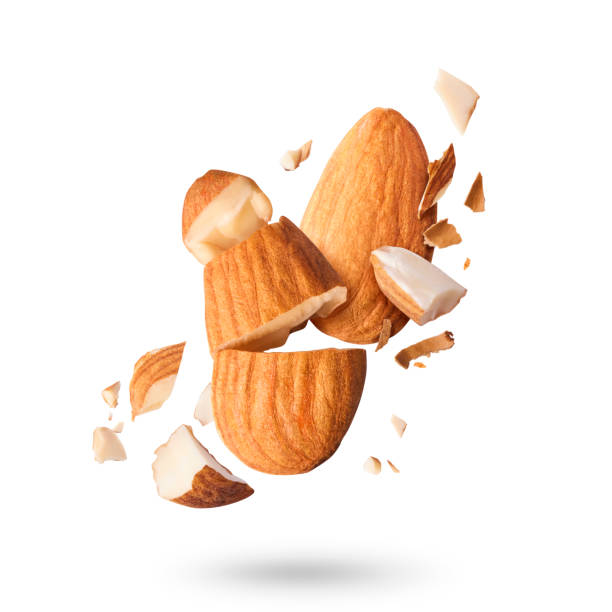 Fresh raw almond. Organic healthy snack Flying in air fresh raw whole and cut almonds  isolated on white background. Concept of Almonds is torn to pieces close-up. High resolution image almond stock pictures, royalty-free photos & images