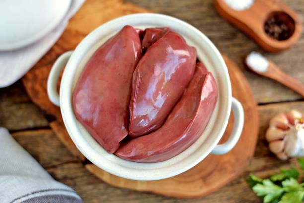 Fresh raw organics turkey liver on an old wooden background. Rustic food. stock photo