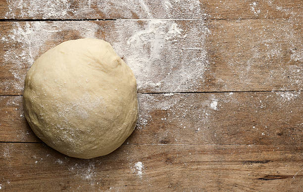fresh raw pizza dogh fresh raw pizza dough on rustic wooden table, top view dough stock pictures, royalty-free photos & images
