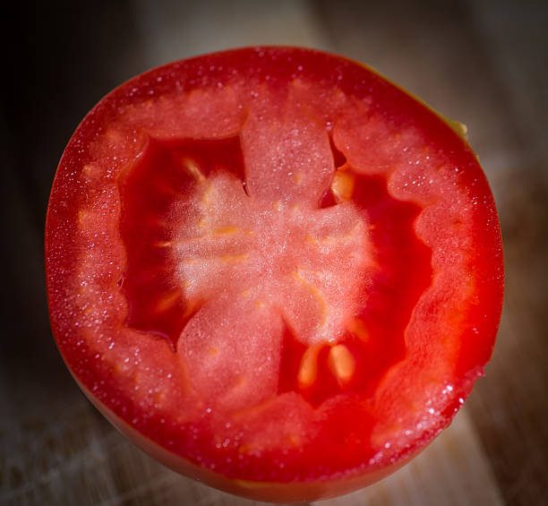 Fresh raw tomatoes on wooden background. Selective focus with very...