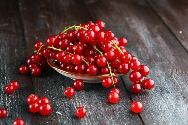 Fresh red currants on light rustic table. Healthy summer fruits stock photo