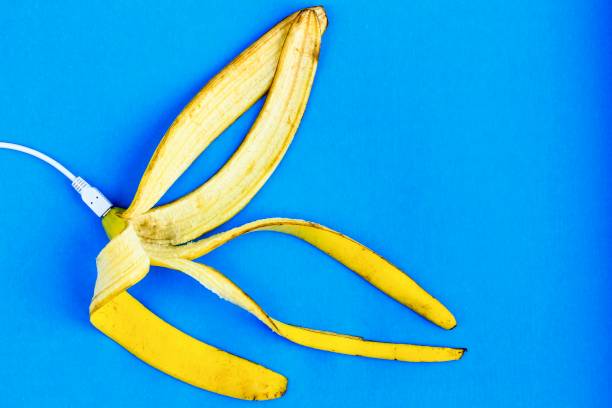 A fresh ripe banana connecting with a white usb charge cable. Creative concept of alternative electricity source, battery charger indicator, energy, healthy food. A fresh ripe banana connecting with a white usb charge cable. Creative concept of alternative electricity source, battery charger indicator, energy, healthy food. Live Sex Streaming stock pictures, royalty-free photos & images