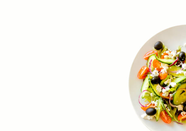 Fresh salad on a white plate with white background stock photo