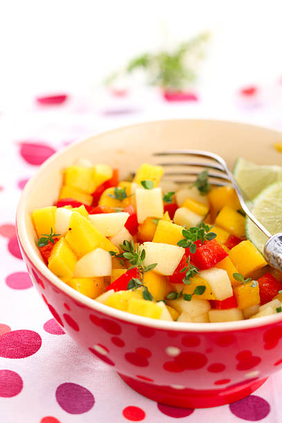 Fresh salad with mango, red pepper, apple and lemon thyme stock photo