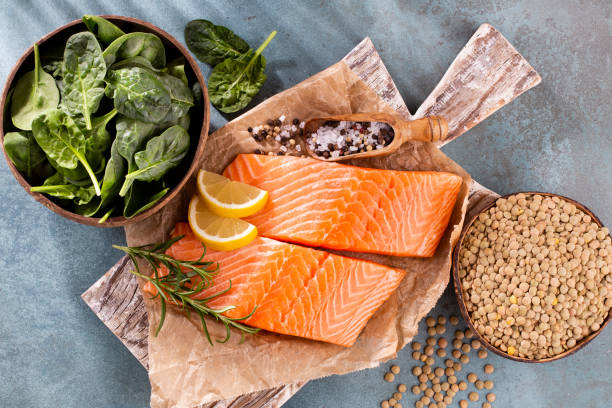 Fresh salmon steak with spinach and lentils. stock photo