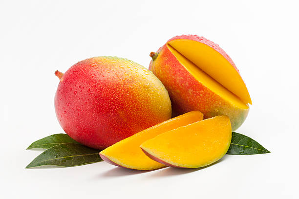 Fresh Slices of Mango on a Bed of Leaves stock photo