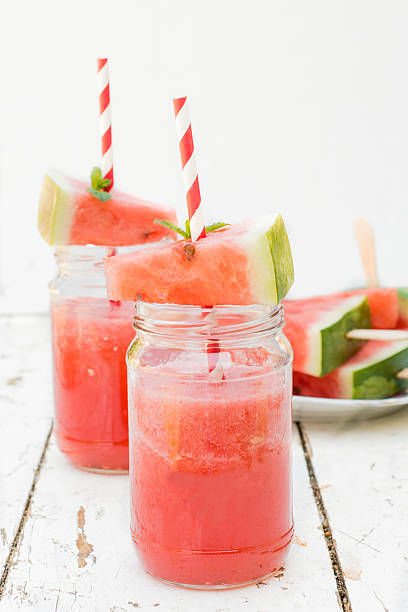 Fresh squeezed watermelon Fresh squeezed juice with watermelon in the jars,selective focus watermelon juice stock pictures, royalty-free photos & images