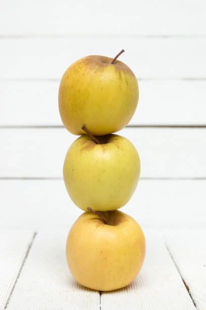 Fresh tasty yellow apple fruits isolated on a white background. stock photo
