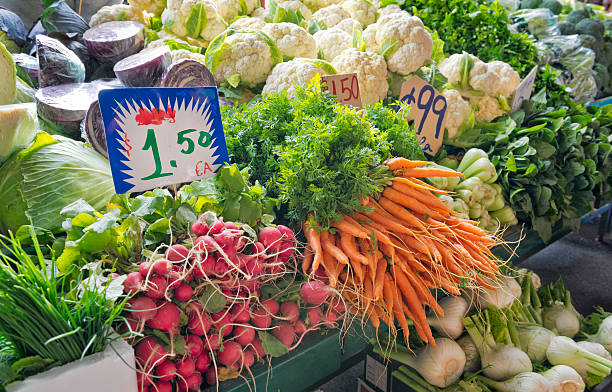 Fresh Vegetables at a Market Stall A vegetable stall at Queen Victoria Market in Melbourne, Australia. queen victoria market stock pictures, royalty-free photos & images