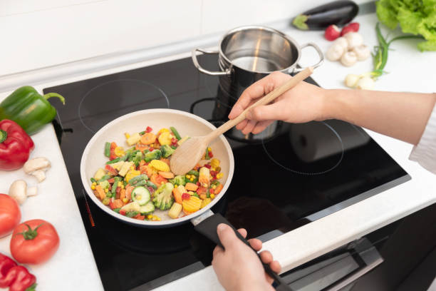 Fresh vegetables fried in a pan. Healthy nutrition concept stock photo
