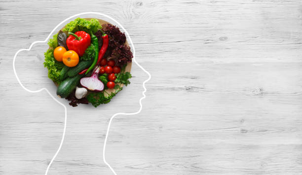 Fresh vegetables in woman head symbolizing health nutrition Health in your brain. Fresh vegetables in woman head symbolizing health nutrition on gray background, panorama, copy space feeding stock pictures, royalty-free photos & images