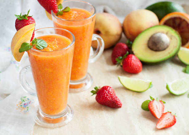 Fresh vitamins drink smoothie with ingredients Fresh vitamins drink smoothie with ingredients orange, avocado, peaches, lime on white wooden table peach smoothie stock pictures, royalty-free photos & images