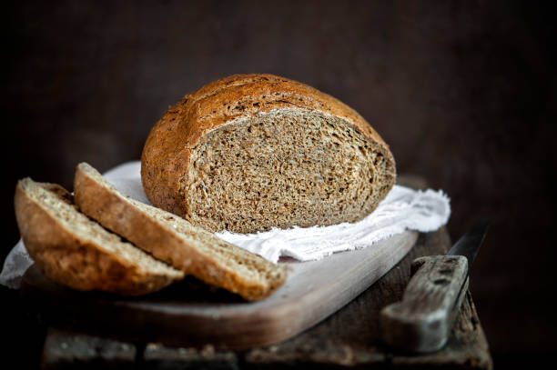 Freshly baked bread on a rustic background Freshly baked bread on a rustic background 7 grain bread photos stock pictures, royalty-free photos & images