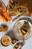 istock Freshly baked carrot cake slice and table decoration, studio shot cake on white background, stock photo of carrot cake, slice cake, kitchenware 1387581763