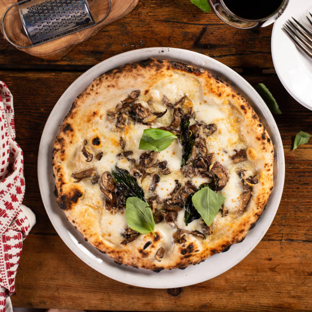Freshly baked Neapolitan pizza with cheese and mushrooms stock photo