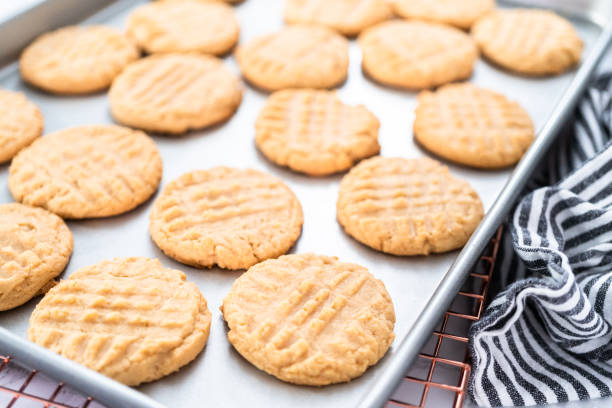 Freshly baked peanut butter cookies Freshly baked peanut butter cookies on a baking sheet. baking sheet stock pictures, royalty-free photos & images