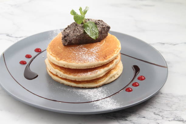 Freshly made Pancakes with chocolate frosting stock photo