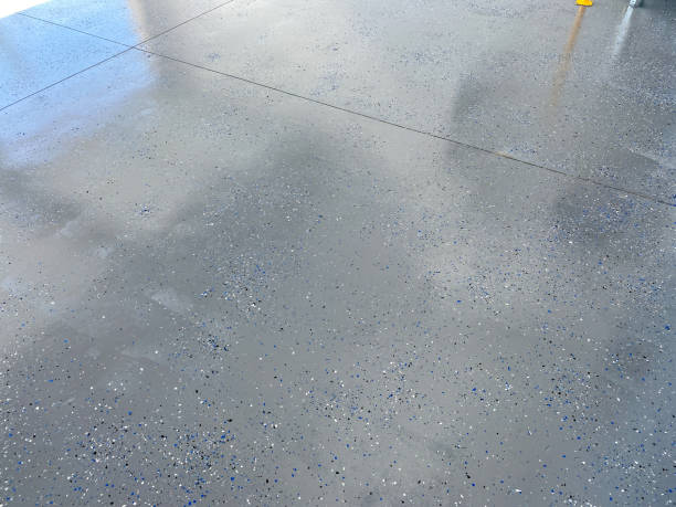 A freshly painted with a gray epoxy finish A freshly painted with a gray epoxy finish sprinkled with blue, black and white plastic chips. flooring stock pictures, royalty-free photos & images