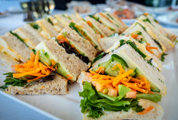Freshly prepared sandwiches arranged on a large plate stock photo