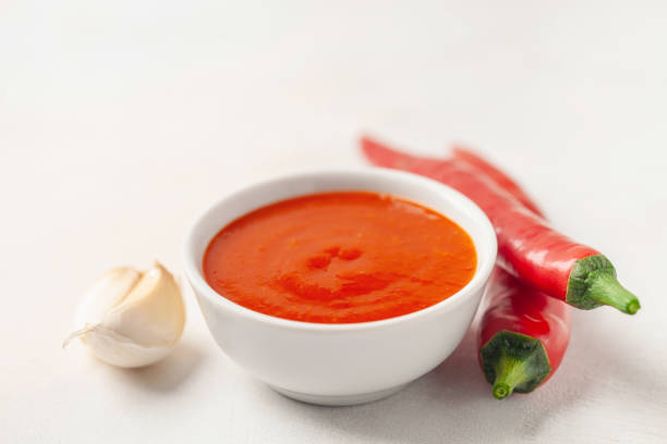 Freshly Sriracha Hot chilli Sauce in bowl on the table. stock photo