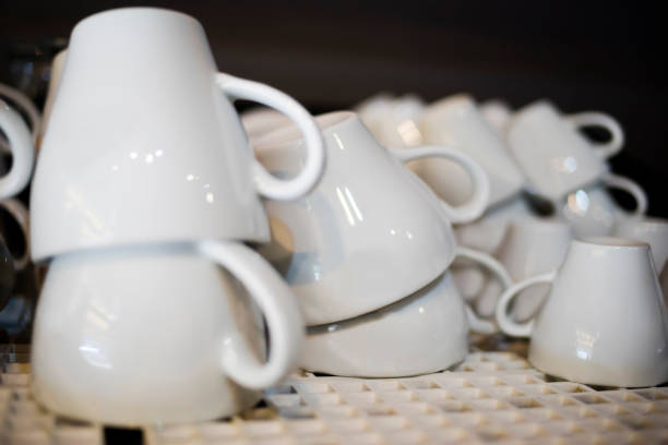 Freshly washed ceramic coffee cups rinsing stock photo