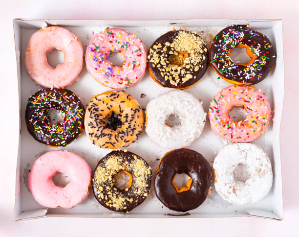 Freshy baked donuts in a cardboard delivery box stock photo
