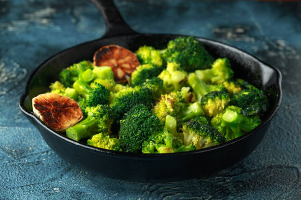 Fried broccoli in cast iron skillet, frying pan Fried broccoli in cast iron skillet, frying pan. broccoli rabe stock pictures, royalty-free photos & images