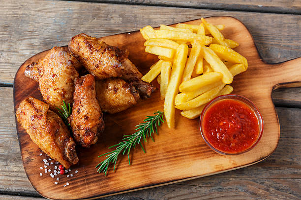 fried chicken wings french fries and sauce stock photo