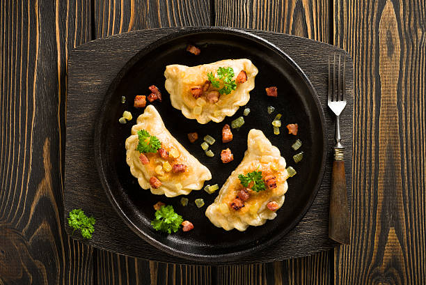 Fried dumplings with onion and bacon top view stock photo