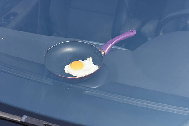 fried egg cooking in a closed car stock photo