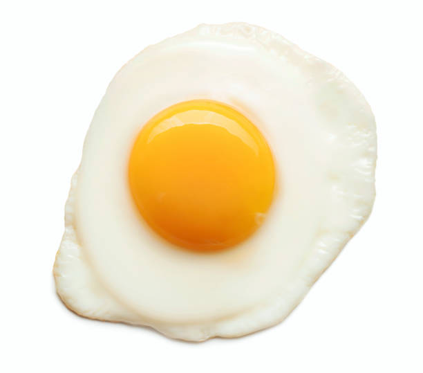 fried egg isolated top view of fried egg with shiny yolk isolated on white background fried egg photos stock pictures, royalty-free photos & images