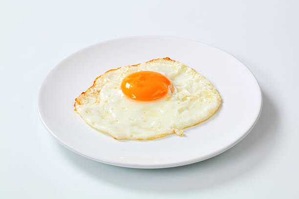 Fried egg Fried egg - sunny side up fried egg photos stock pictures, royalty-free photos & images