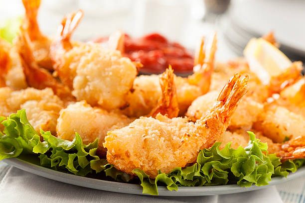 Fried Organic Coconut Shrimp Fried Organic Coconut Shrimp with Cocktail Sauce cocktail sauce stock pictures, royalty-free photos & images