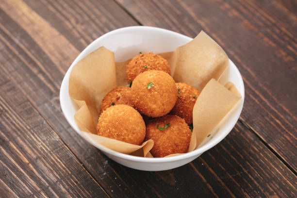 Fried potato balls served on a white plate as beer snack stock photo