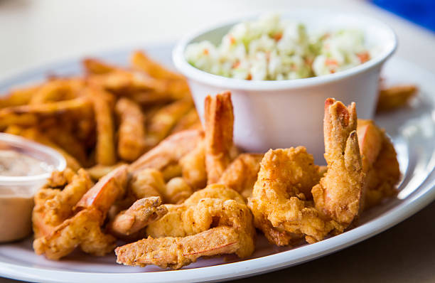 Fried Shrimp with Fries and Coleslaw A fried shrimp dinner with french fries, coleslaw and sauce fried stock pictures, royalty-free photos & images