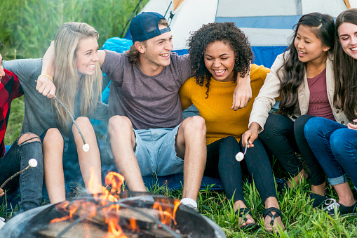 Friends Hanging Out Around The Campfire Stock Photo ...