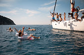 istock Friends jumping in sea 1385096023