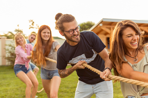 Friends-playing-tug-of-war-at-an-outdoor-summertime-party-picture-id1295287581? B=1&k=20&m=1295287581&s=170667a&w=0&h=kt2xmcvsamdgdwf4asga0r5gf8bactnrqjnxcgqgals=