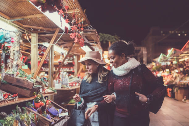 Friends shopping Christmas presents Mixed race girls shopping for Christmas christmas market stock pictures, royalty-free photos & images