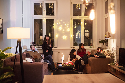 Friends Talking While Sitting In Living Room During Friends Talking While Sitting In Living Room During