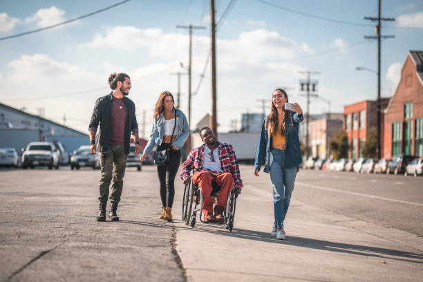 friends walking on the street of los angeles and taking a selfie. - wheelchair street happy imagens e fotografias de stock
