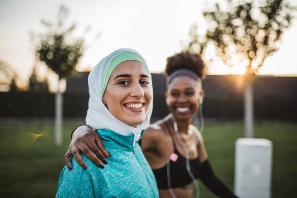 Friends working out together Two young women, different ethnicity ,exercisng outdoor. They are wearing sport clothing.
Getting ready for training. hijab stock pictures, royalty-free photos & images