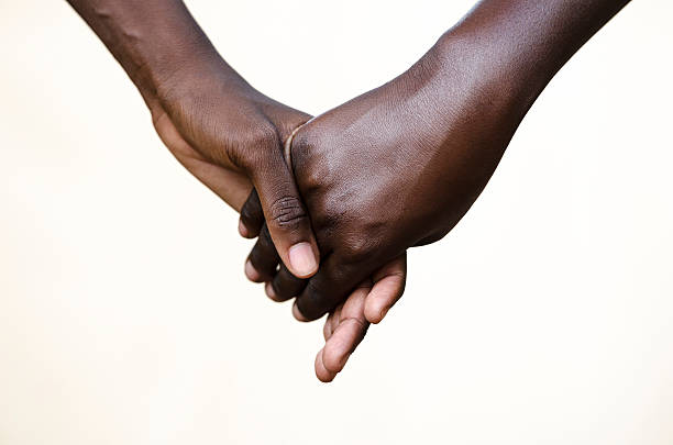 Friendship Symbol: Black People Holding Hands Together stock photo