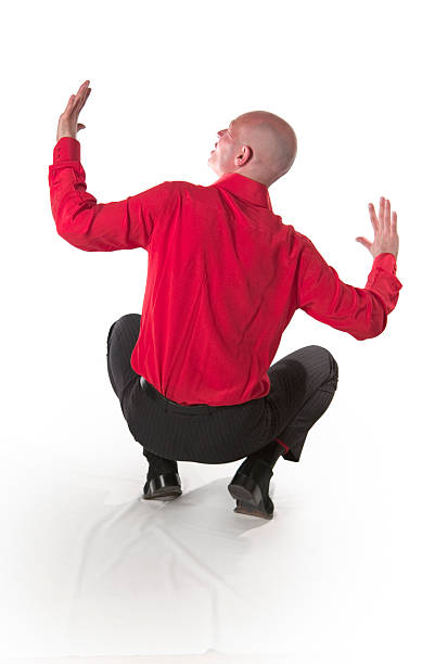 Frightened man crouching stock photo