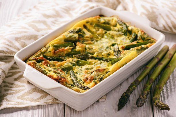 Fritata with asparagus on wooden background. stock photo