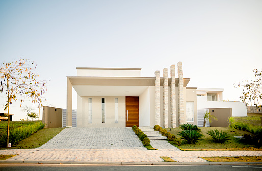 Stylish facade of a modern home with contemporary architectural features on a late afternoon in the summertime